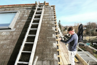 A worker from 5 Star Roofcare is seen carrying out roof repairs on a pitched roof