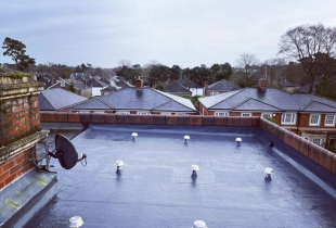 Flat roof with lead roof flashing and roof ventilation turbines carried out by 5 Star Roof Care in Surrey