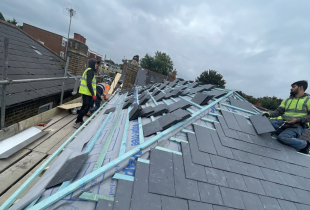 Men from 5 Star Roofcare diligently working on a slate roof, ensuring quality and precision.