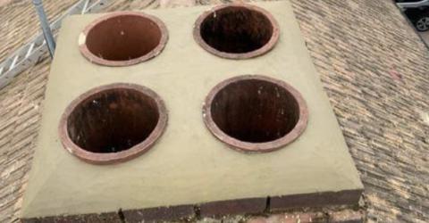 A chimney with four pots on top, showcasing the repair work carried out by 5 Star Roofcare.